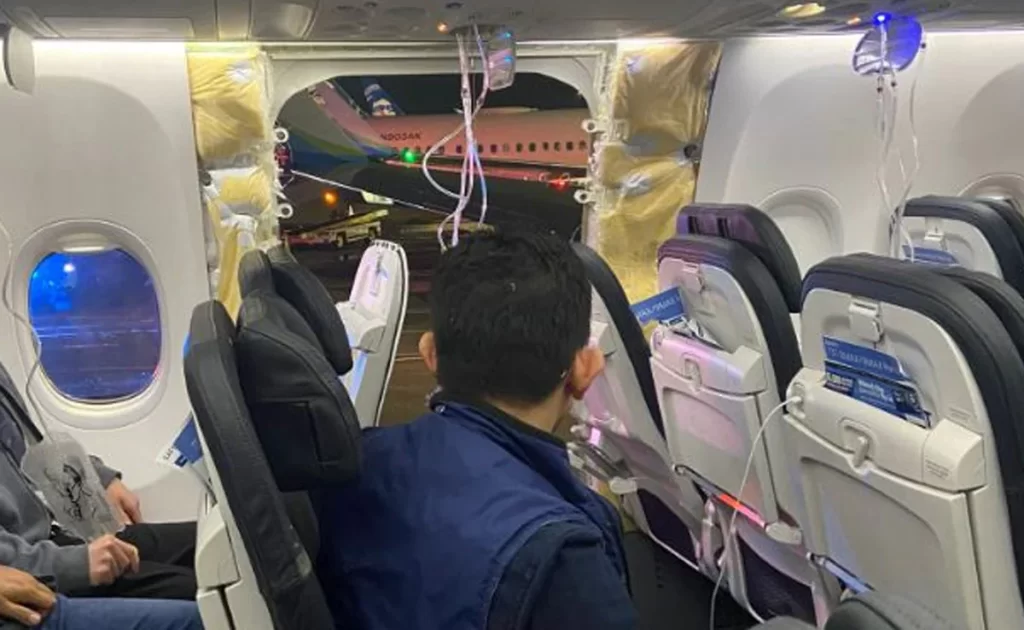 Alaska Airlines Boeing 737 MAX passenger looking at the blown off door.